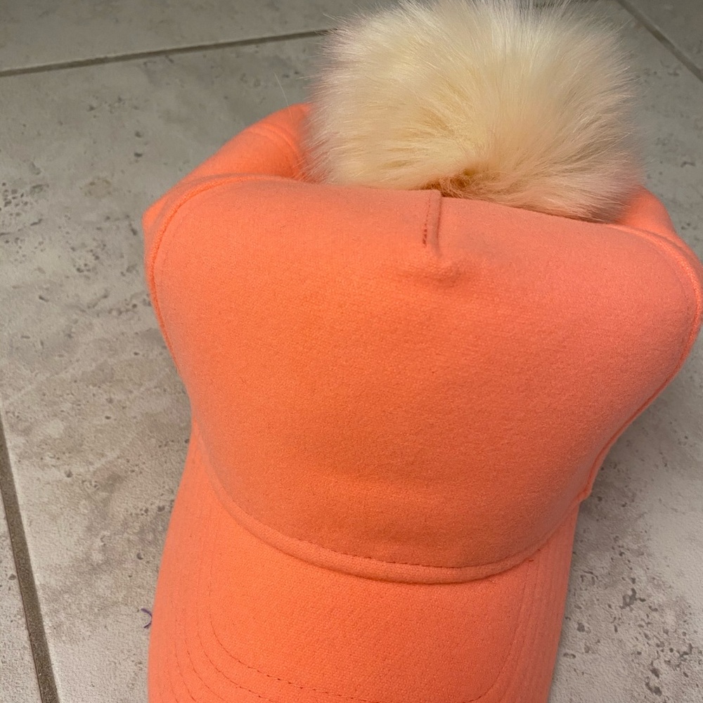 Peach color baseball cap with faux fur pom pom